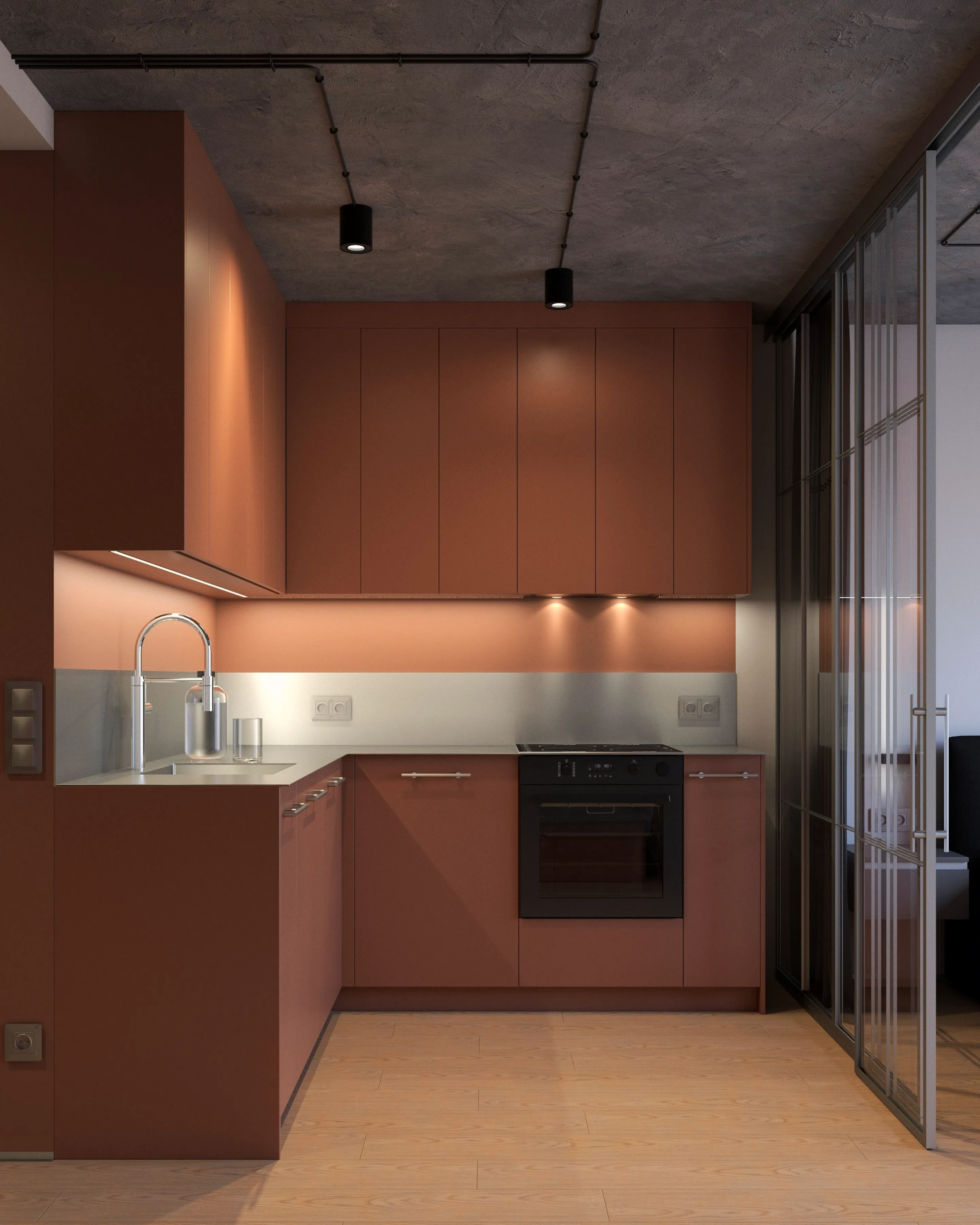 Kuchnia w kawalerce: terrakotowe szafki od podłogi do sufitu, układ w literę L, oświetlenie LED pod szafkami, betonowy sufit – projekt małego mieszkania w Warszawie.