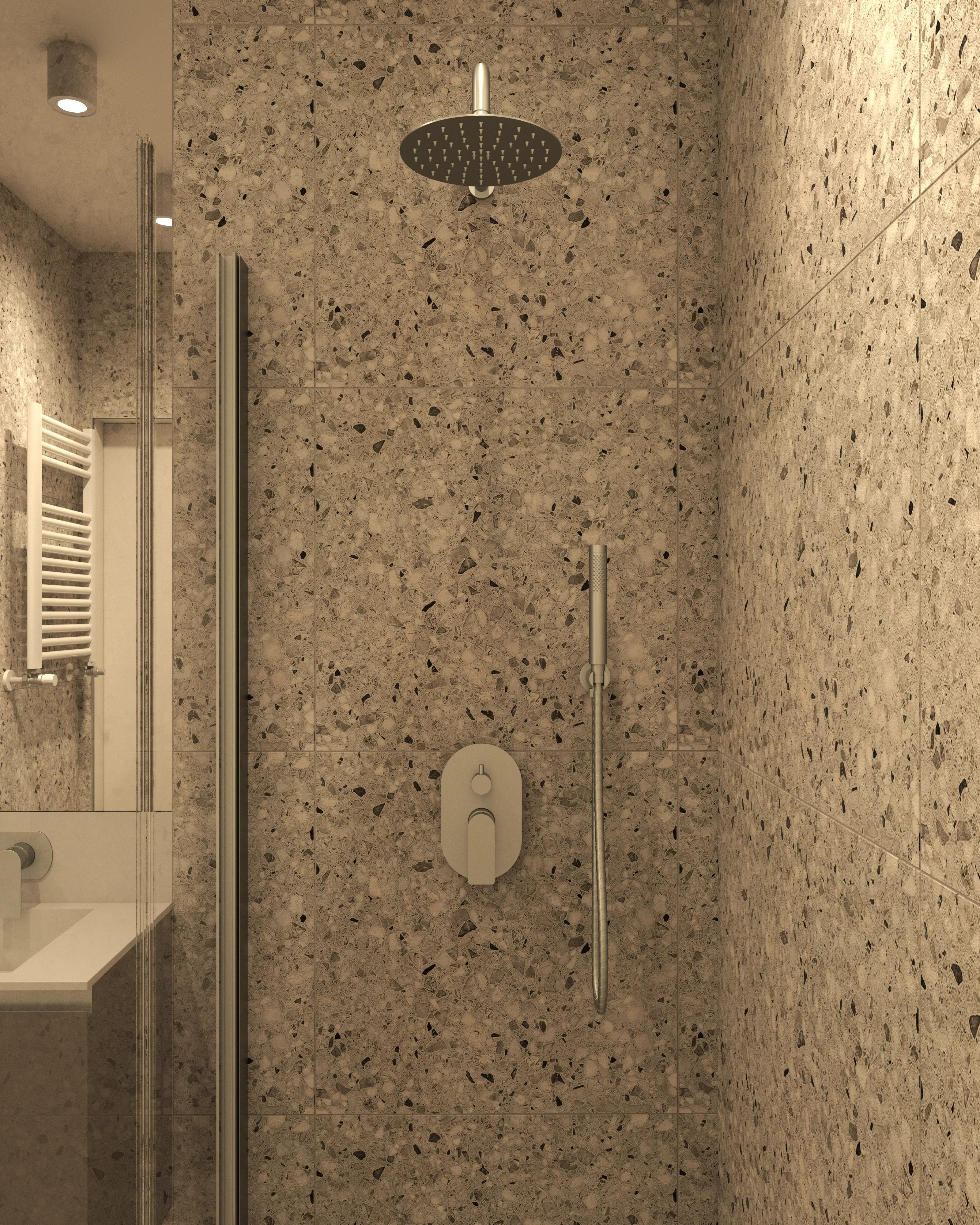 Łazienka w kawalerce: kabina prysznicowa z deszczownicą, beżowe płytki terrazzo, stalowa armatura – kompaktowa aranżacja małej łazienki.