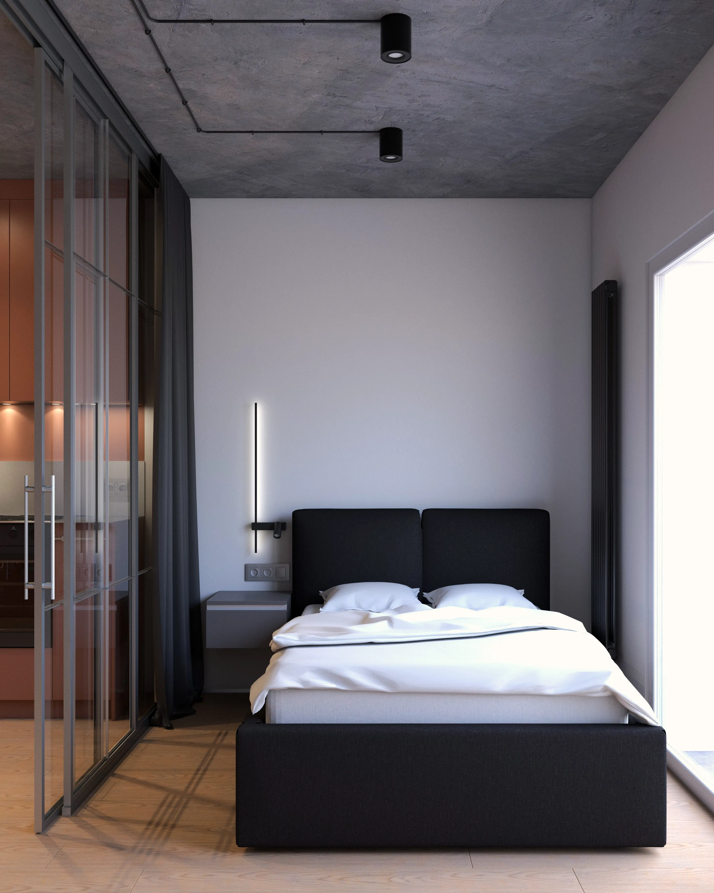 Sypialnia w kawalerce: ciemne tapicerowane łóżko, biała pościel, betonowy sufit, pionowa lampa ścienna, szklana ścianka działowa i duże okno – projekt Nalalab.